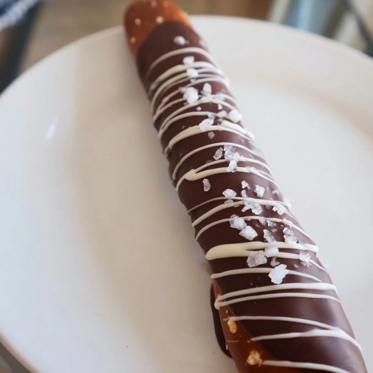 Chocolate dipped pretzels gleaming with flaky sea salt, a satisfyingly sweet and savory snack.