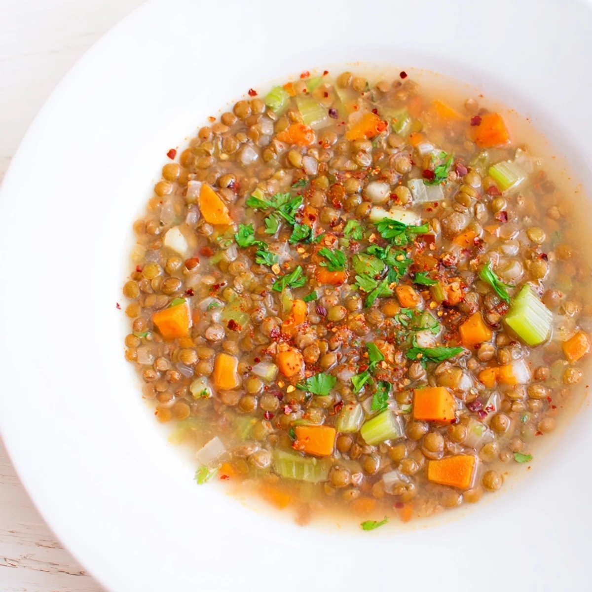 Hearty Spicy Lentil Soup simmering, featuring tender lentils and aromatic vegetables, delicious and warming.