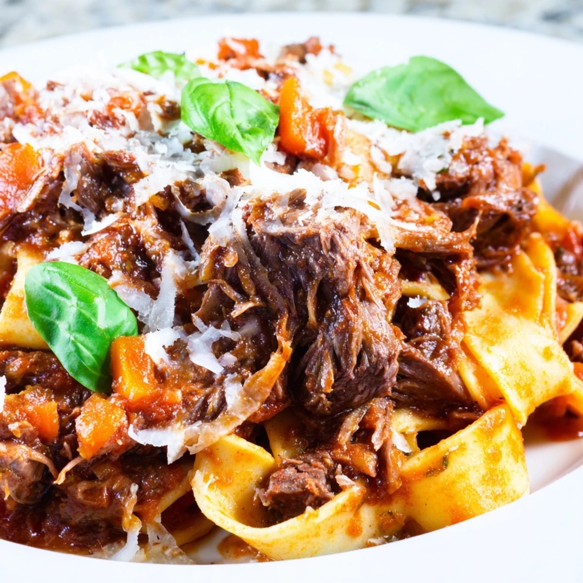 Savory Slow Cooker Beef Ragu with Pappardelle Pasta, beautifully plated with Parmesan and basil, perfect for weeknight comfort food.