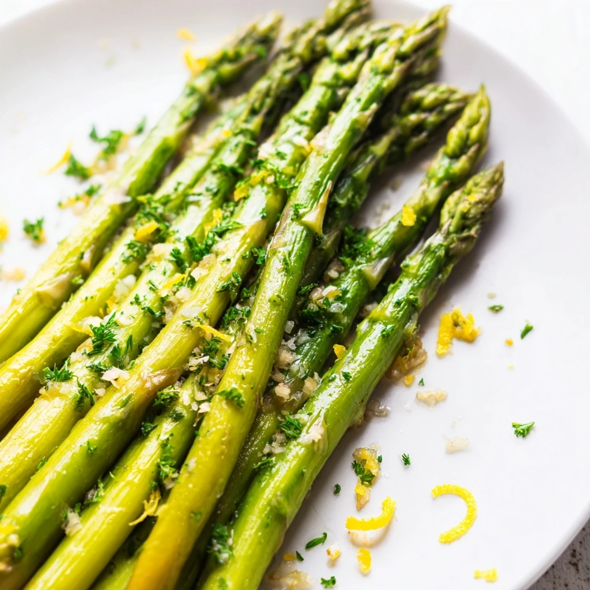 Vivid overhead shot of Lemon Garlic Roasted Asparagus with minced garlic and lemon juice, ready to serve warm.