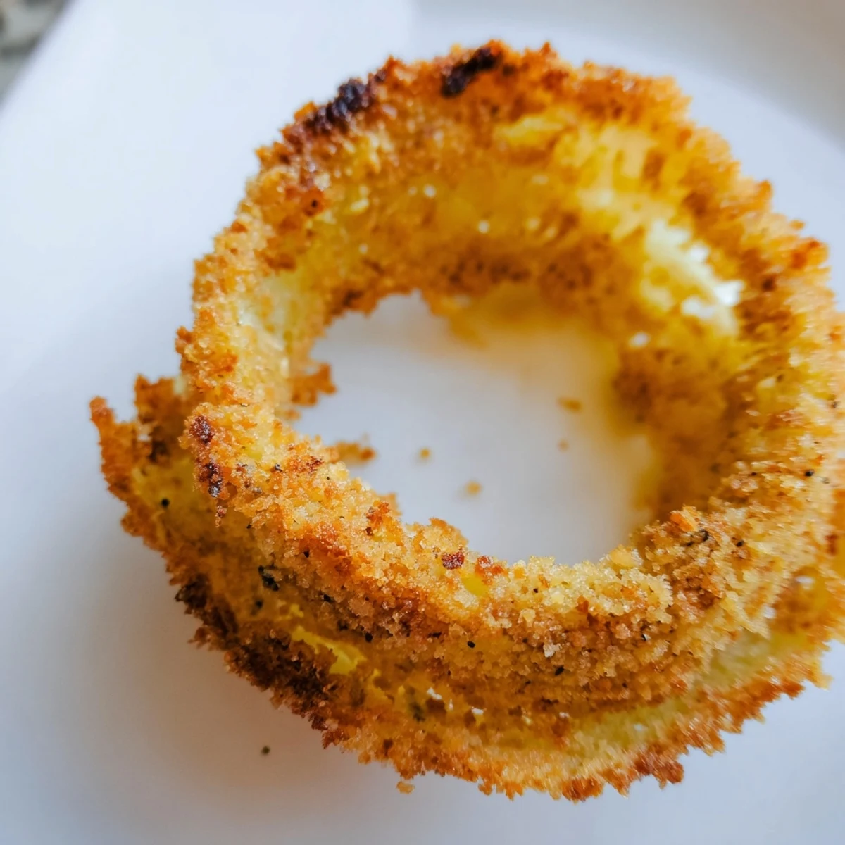 Perfectly golden Crispy Air Fryer Onion Rings arranged on a wire rack, steaming slightly and ready to be dipped in ranch or chipotle mayo.  