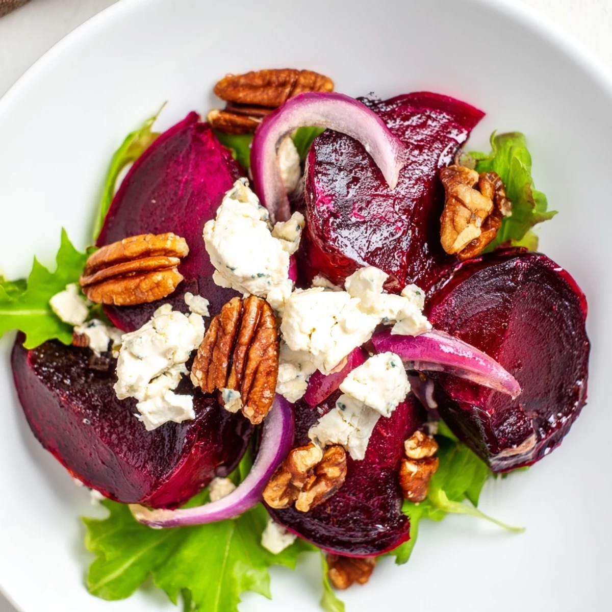 In this Roasted Beet and Goat Cheese Salad with Pecans, golden toasted pecans add crunch, while a tangy vinaigrette ties the vibrant ingredients together. 