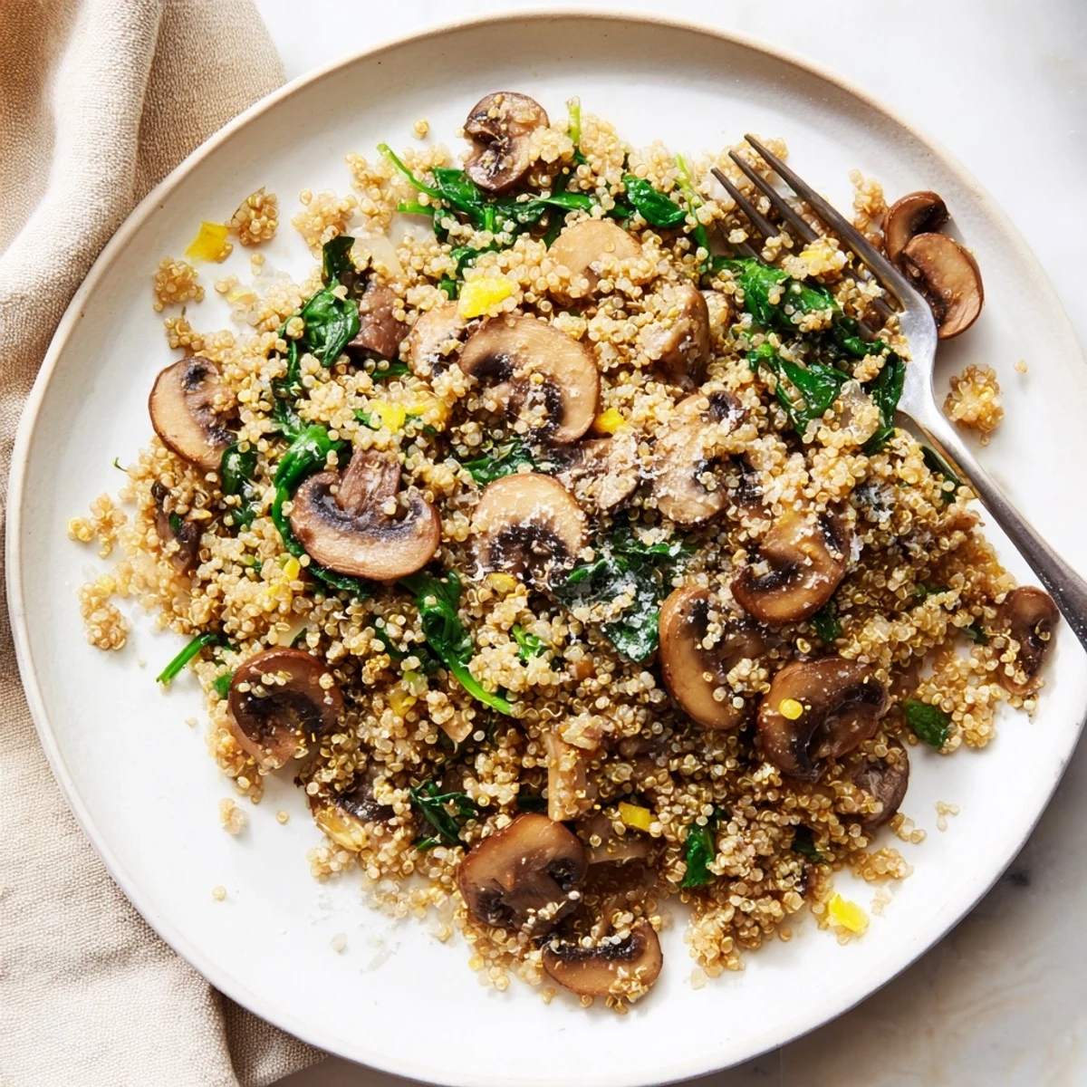 Golden sautéed mushrooms and minced garlic are tossed with fluffy quinoa in this Garlicky Mushroom Quinoa dish.