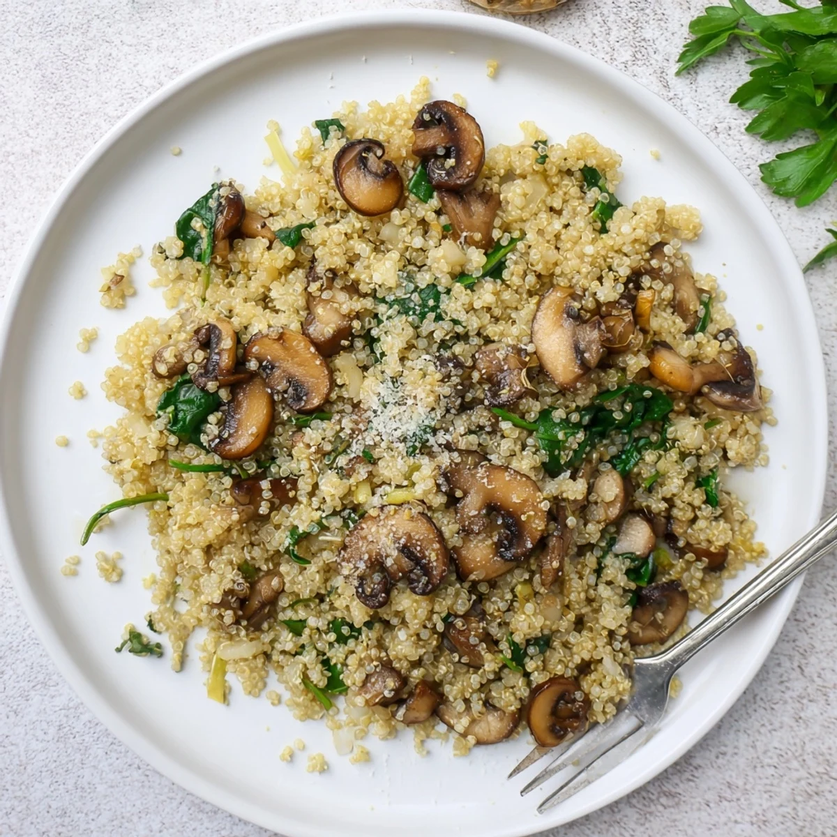 Hearty Garlicky Mushroom Quinoa is served hot with fresh parsley, ideal for a quick vegetarian family meal.