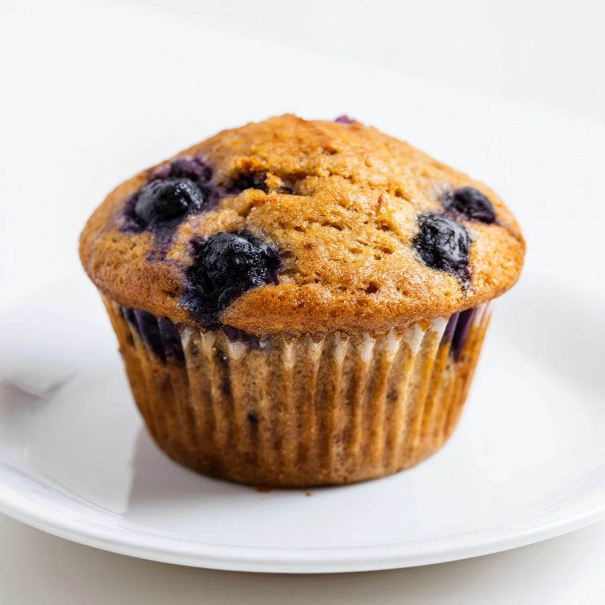 Golden-brown Greek Yogurt Blueberry Protein Muffins cooling on a wire rack, ready for a healthy breakfast.