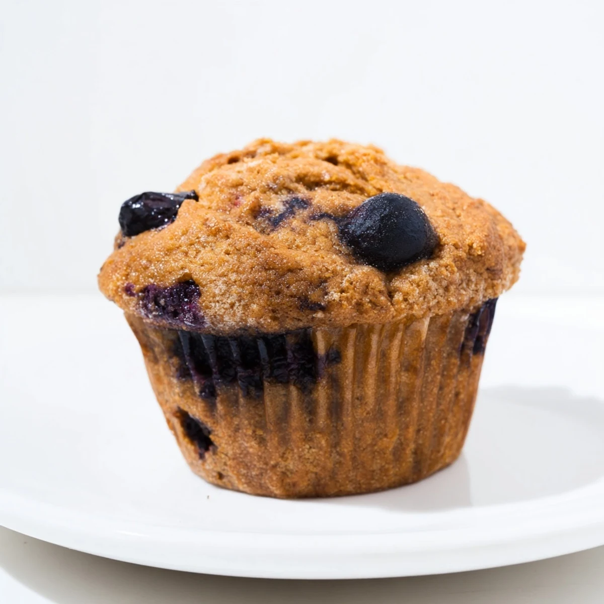 Freshly baked Greek Yogurt Blueberry Protein Muffins with juicy berries and a moist, tender crumb.