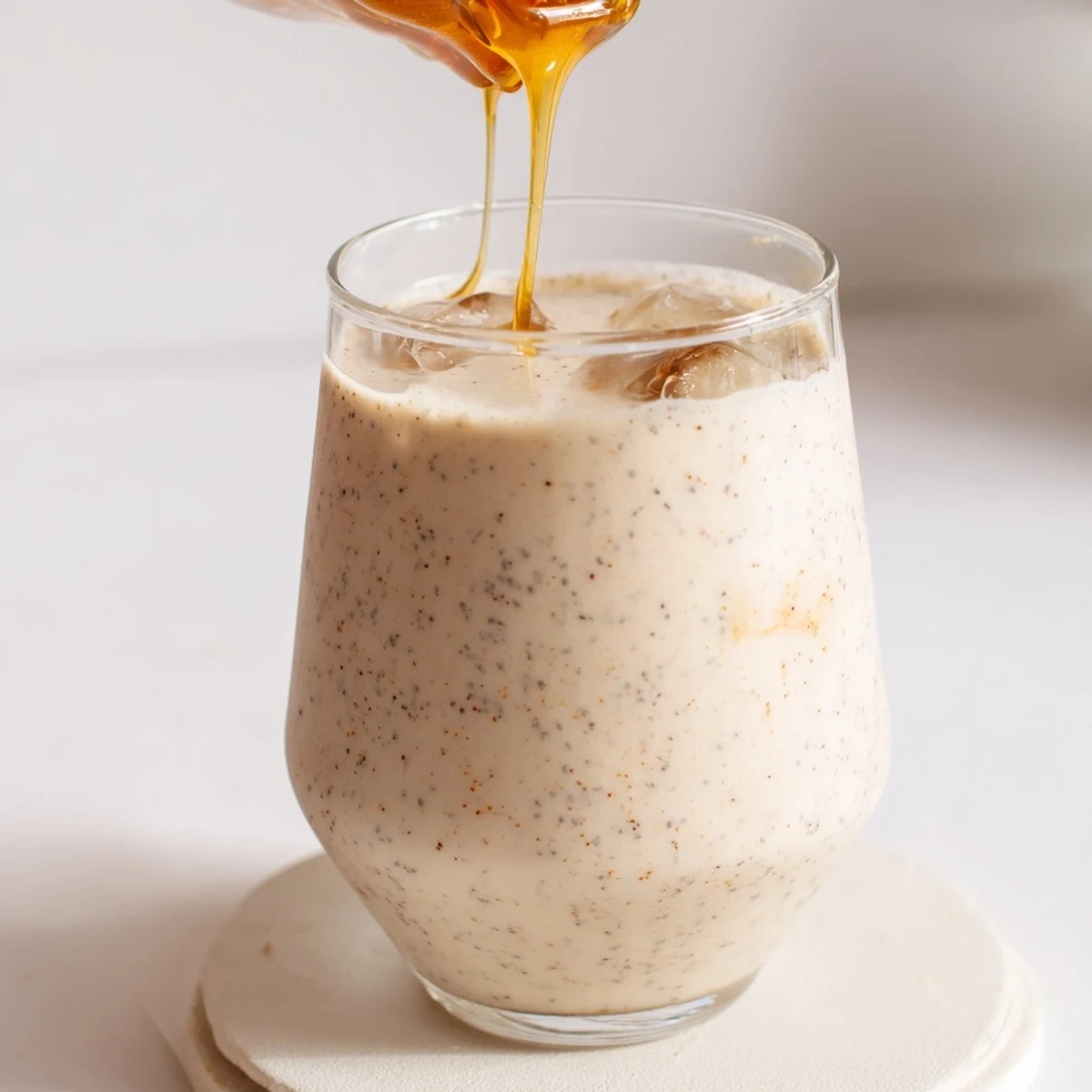 Healthy Greek yogurt banana smoothie with cinnamon swirl in a tall glass garnish