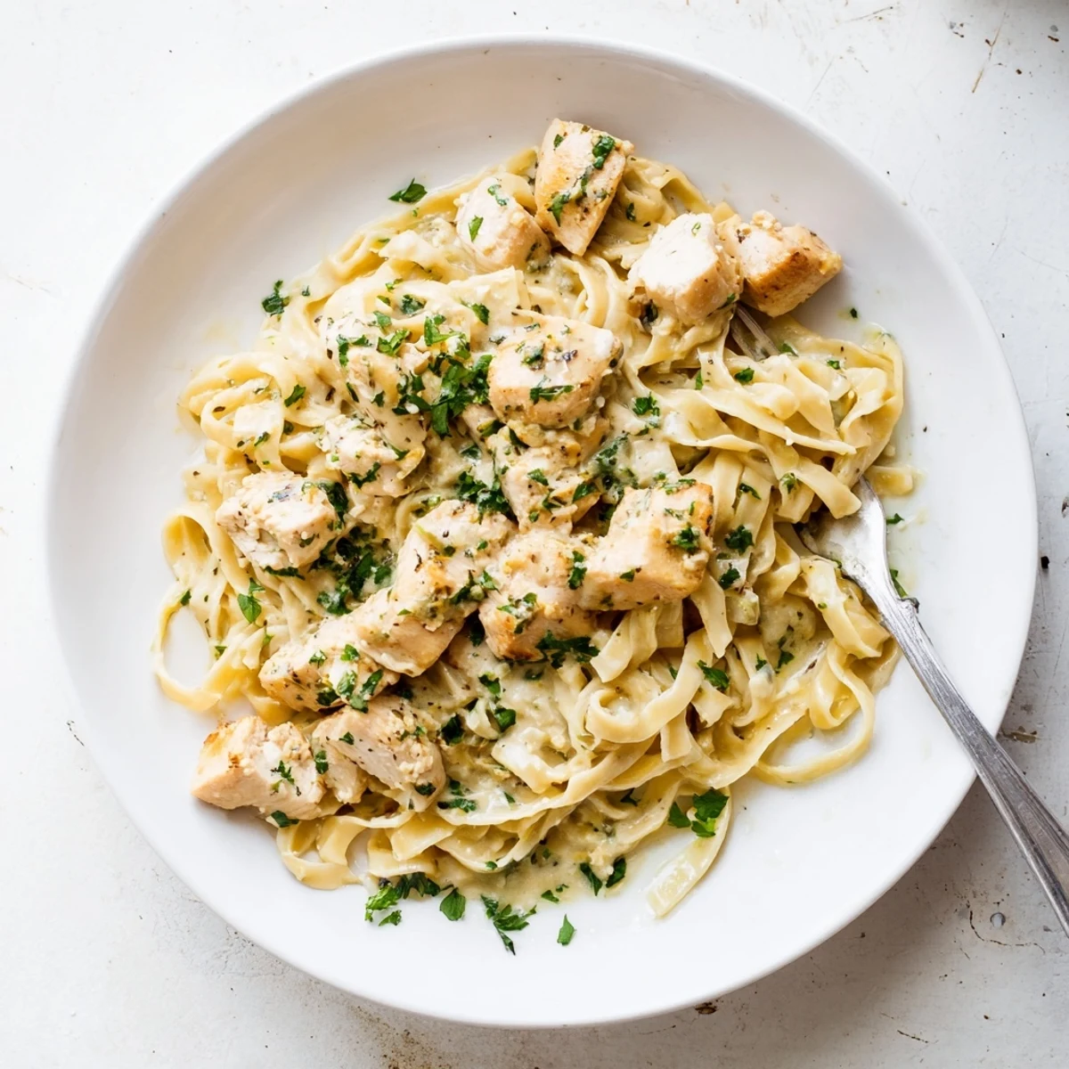 Savory seasoned chicken cooked atop silky buttered noodles in this comforting one pan meal