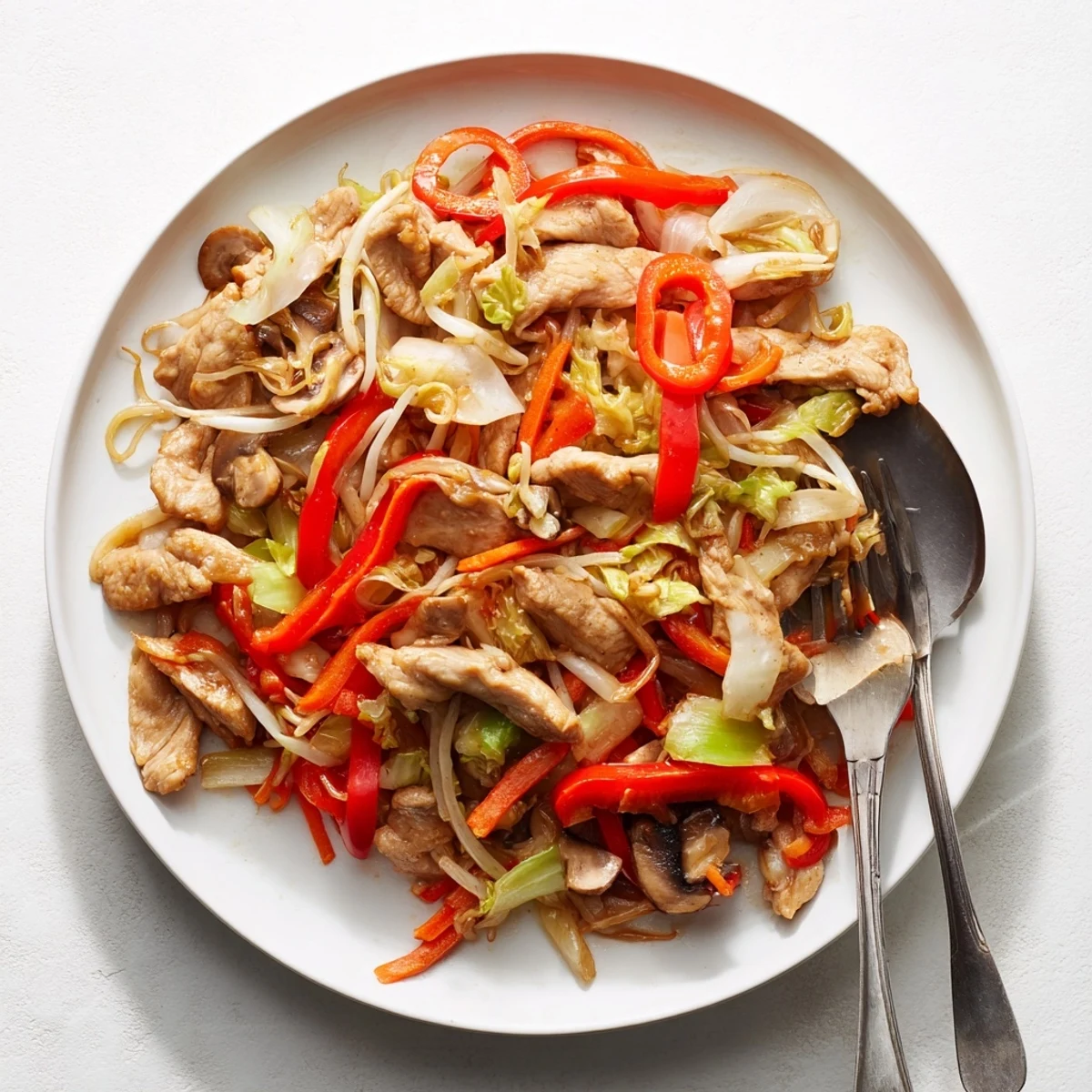 Sizzling wok of Chop Suey with bean sprouts cabbage and sliced chicken in thickened sauce