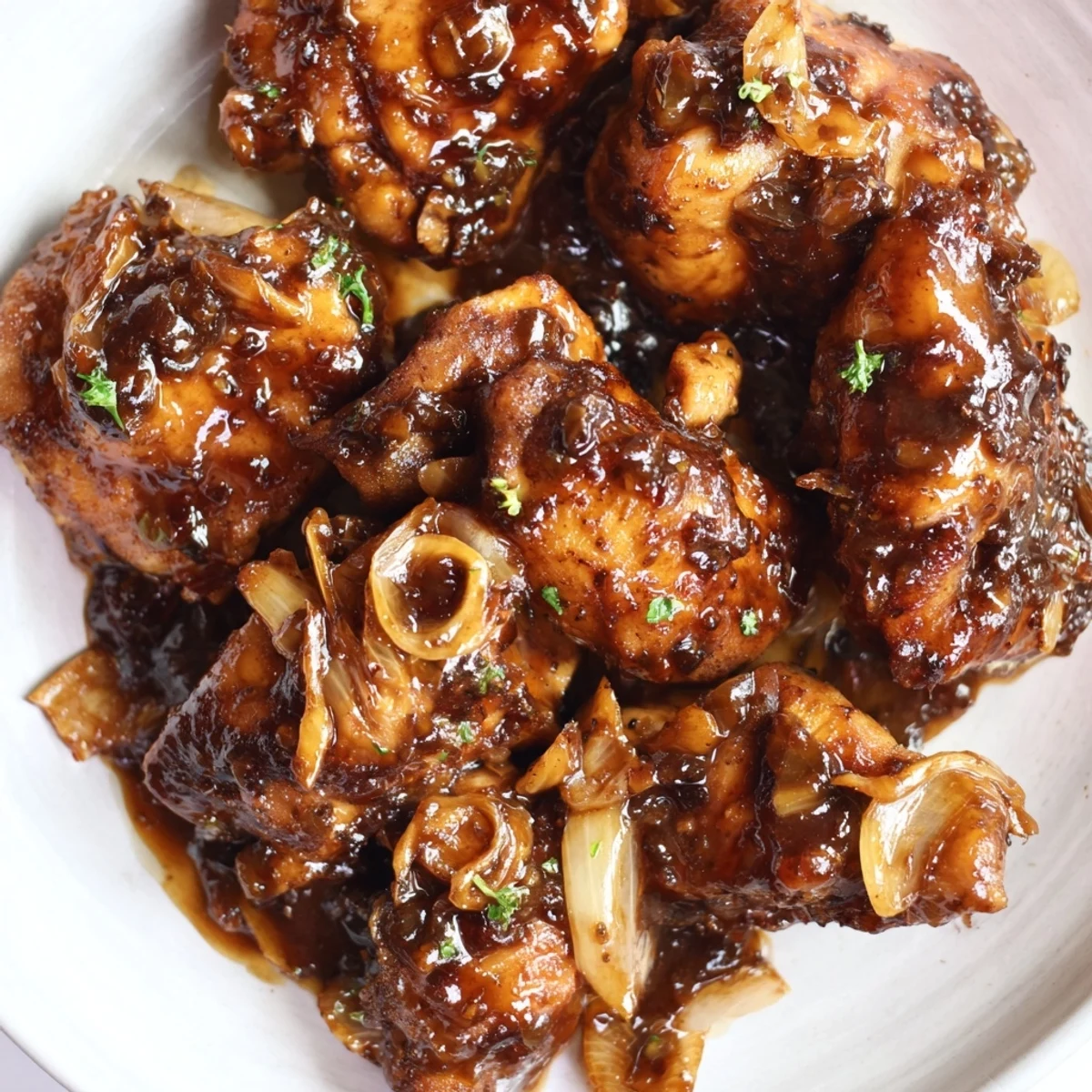 Savory chicken thighs coated in tangy honey balsamic sauce with roasted garlic slices