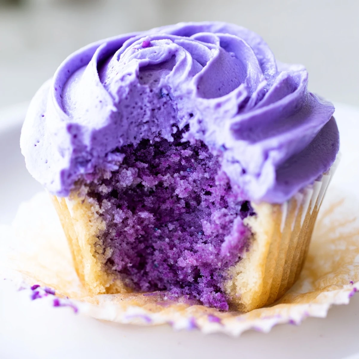 Close up of frosted grape soda cupcakes with swirled purple grape buttercream decoration