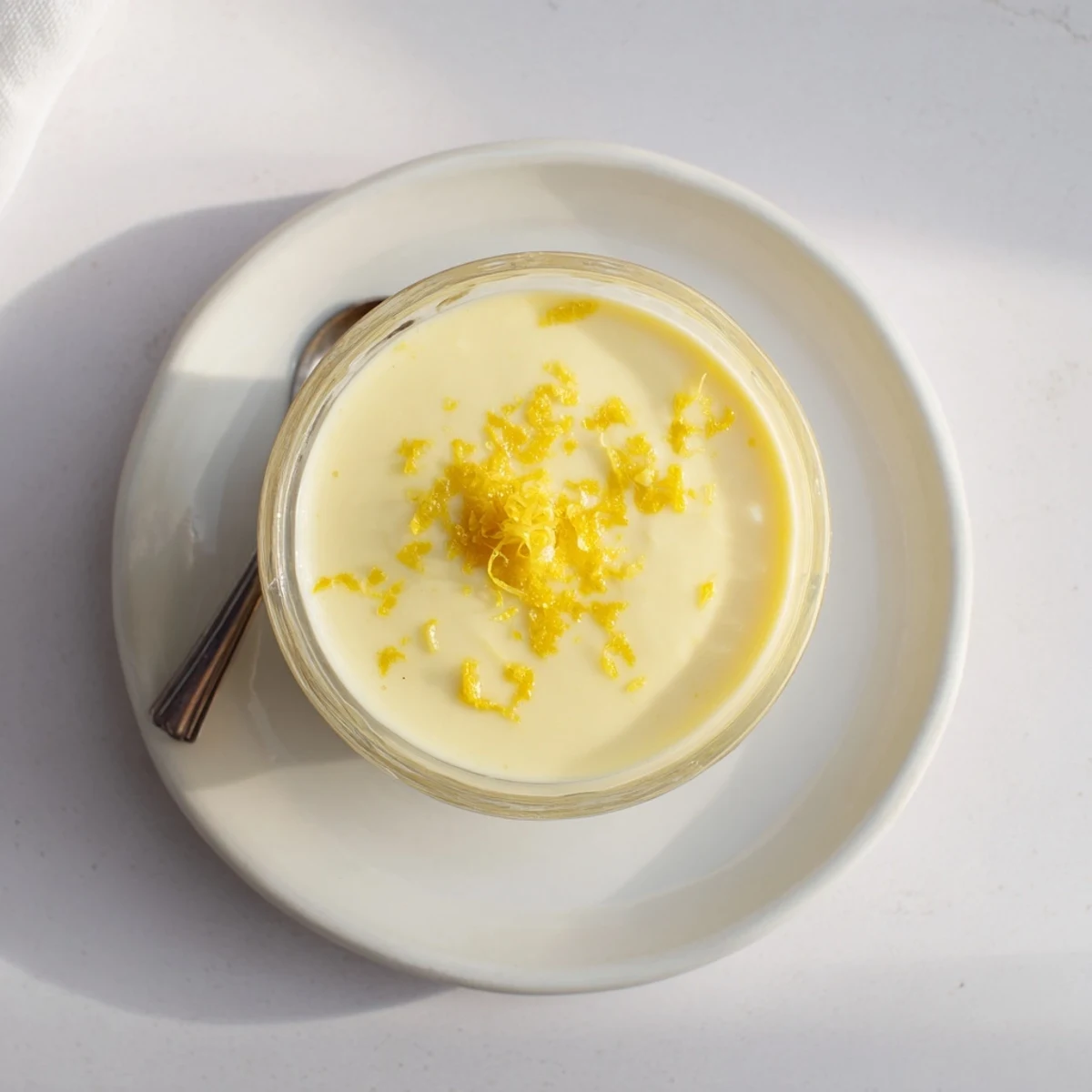 Silky smooth lemon posset dessert set in individual white ramekins