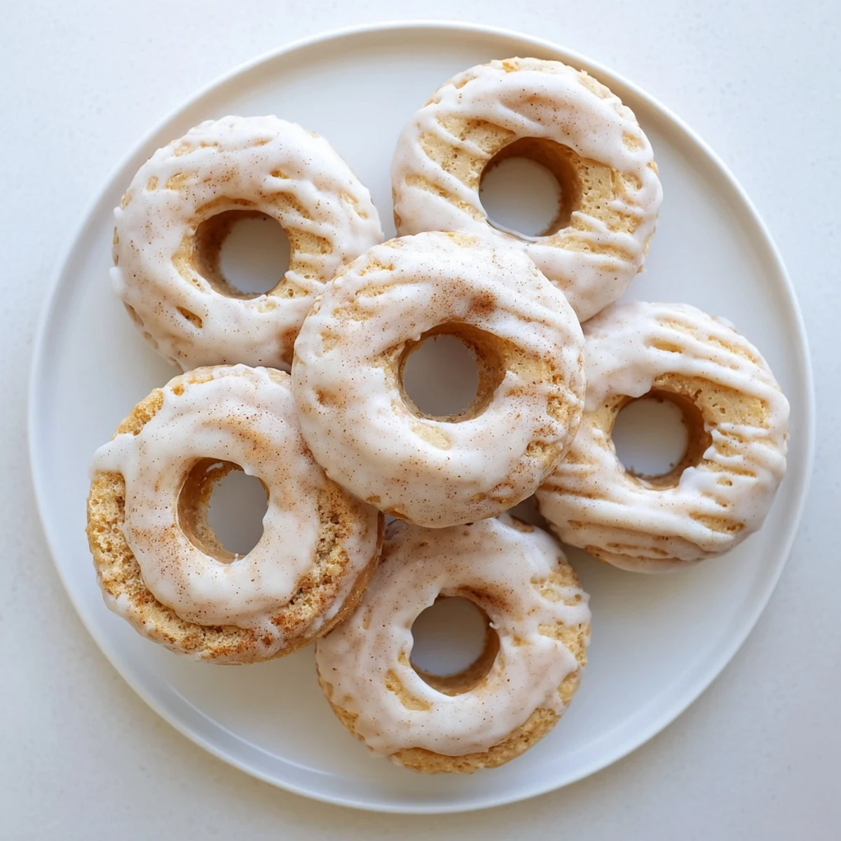 Moist Greek yogurt cake donuts arranged on a serving plate with optional sprinkles