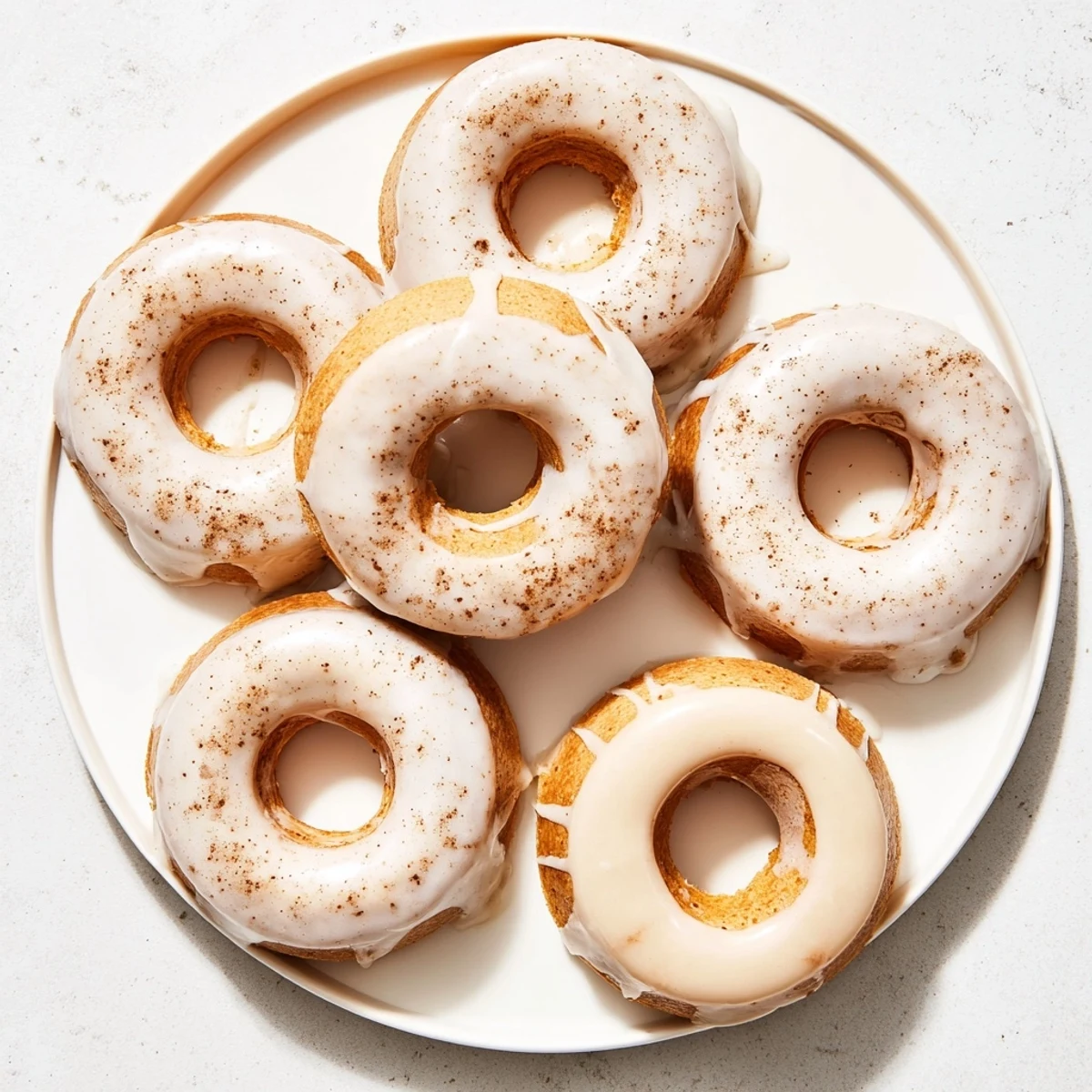 Light and fluffy baked Greek yogurt cake donuts with cinnamon and sweet powdered sugar coating