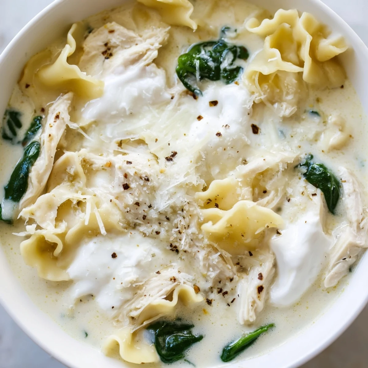 Creamy white lasagna soup loaded with tender chicken, spinach, and melted mozzarella