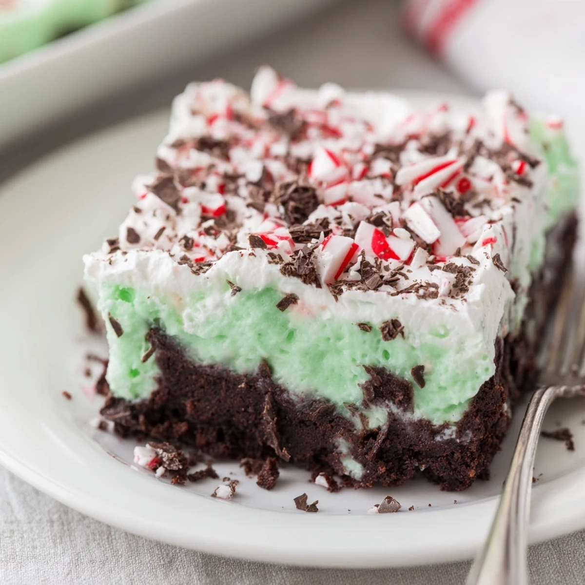 Rich chocolate Peppermint Poke Cake with minty pudding filling, festive holiday garnish