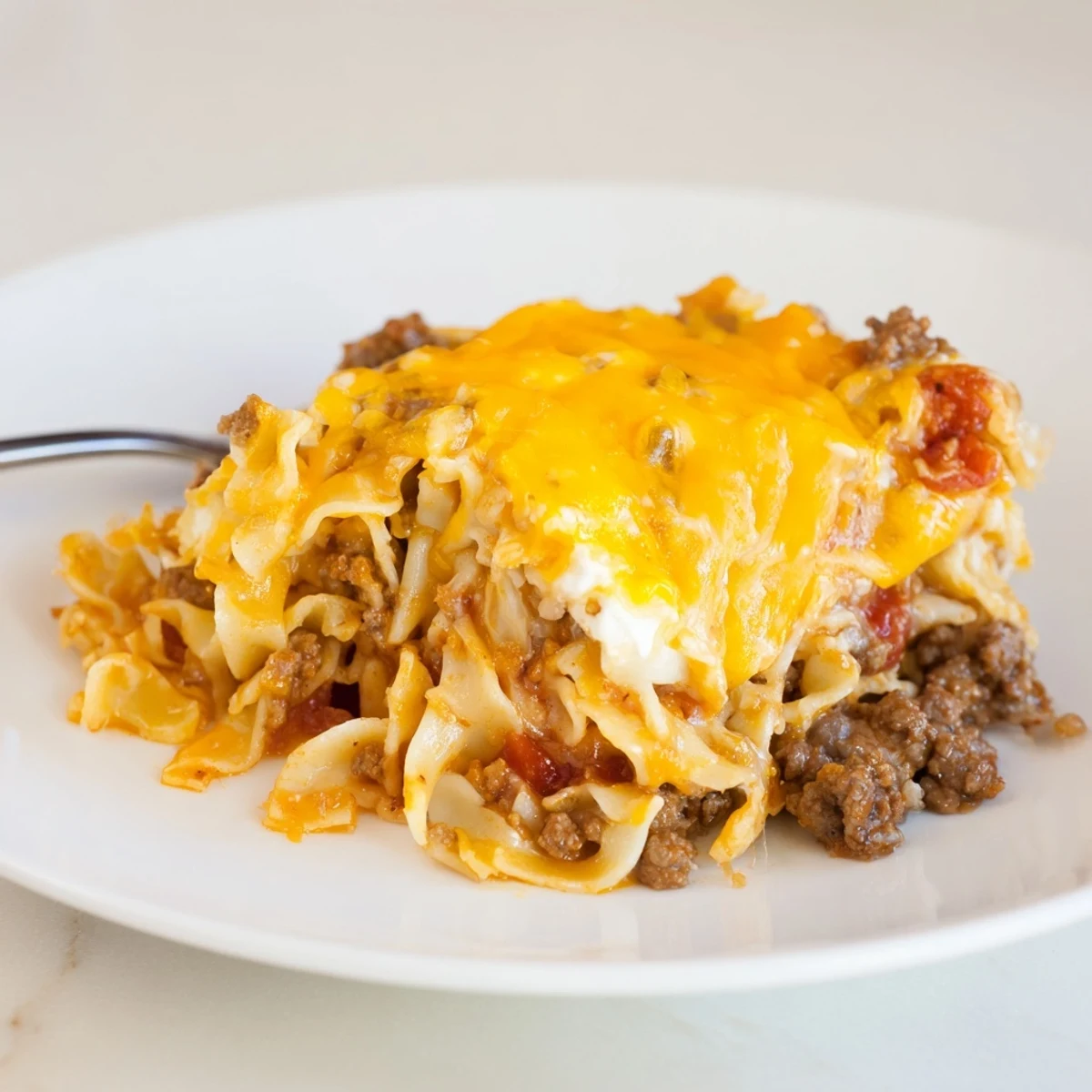 Hearty Beef Lombardi Casserole with savory beef, creamy cheese, steam rising