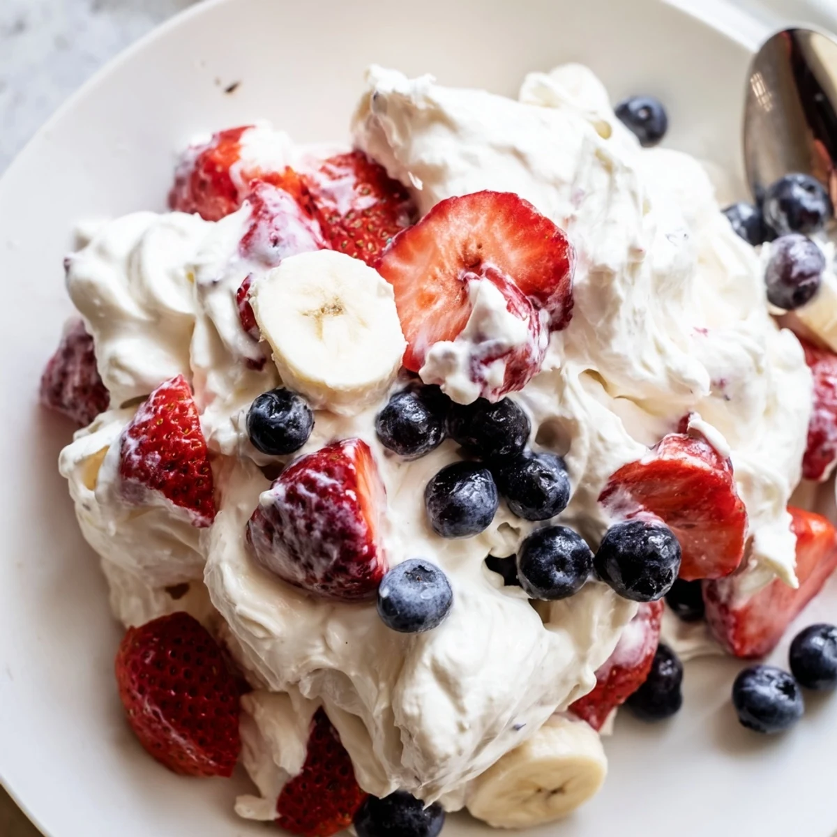 Red White And Blue Cheesecake Salad with creamy filling and juicy chilled berries