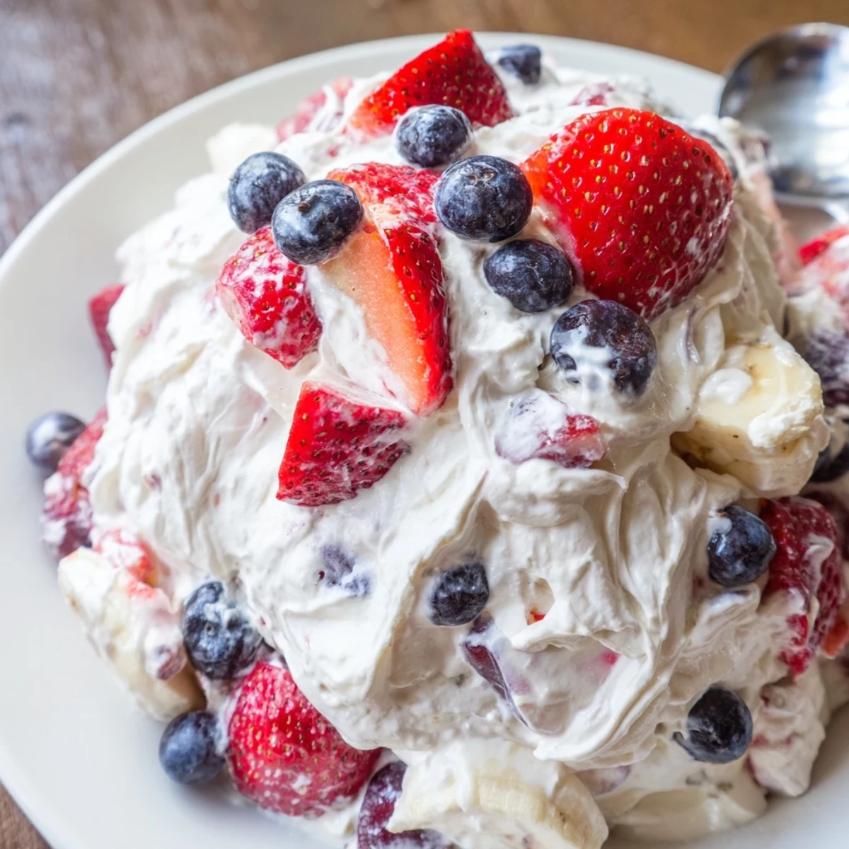 Patriotic Red White And Blue Cheesecake Salad served cold in bowl fluffy texture