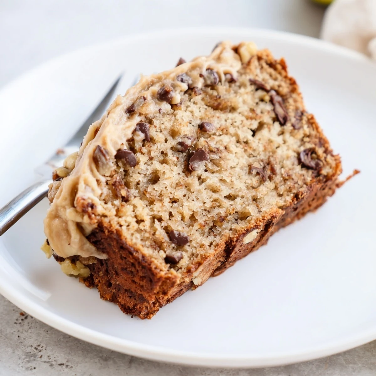 Sliced Banana Bread Cake Recipe with melting butter, moist crumb, cinnamon scent.