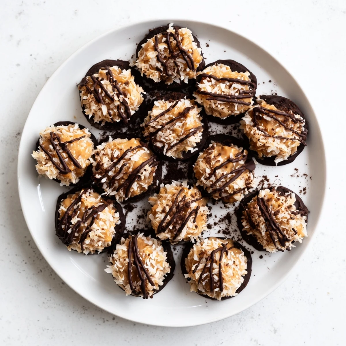 Rich dark chocolate no bake Samoa bites featuring coconut caramel swirl and toasted flakes