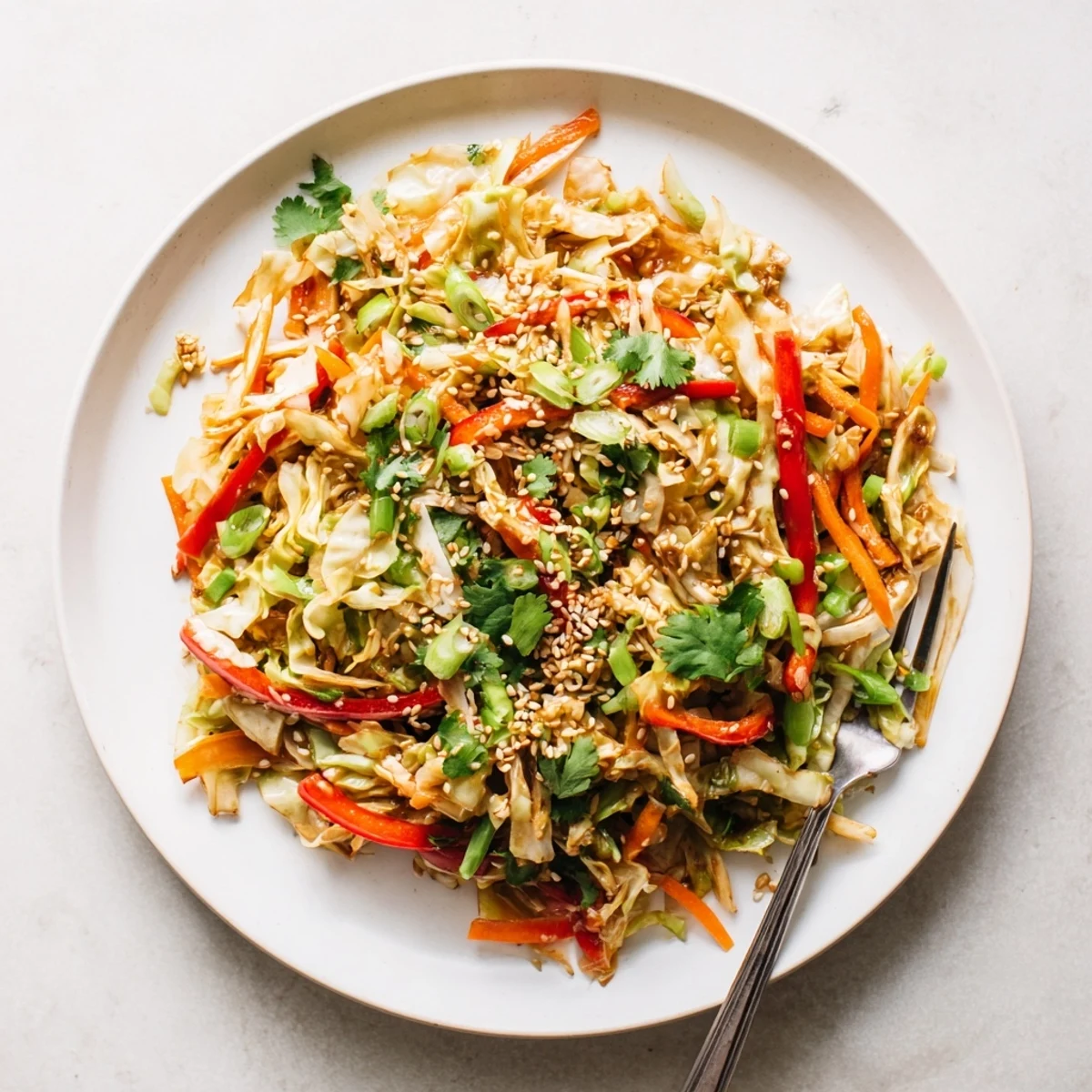 Colorful cabbage stir fry recipe featuring crisp vegetables tossed in glossy savory sesame sauce