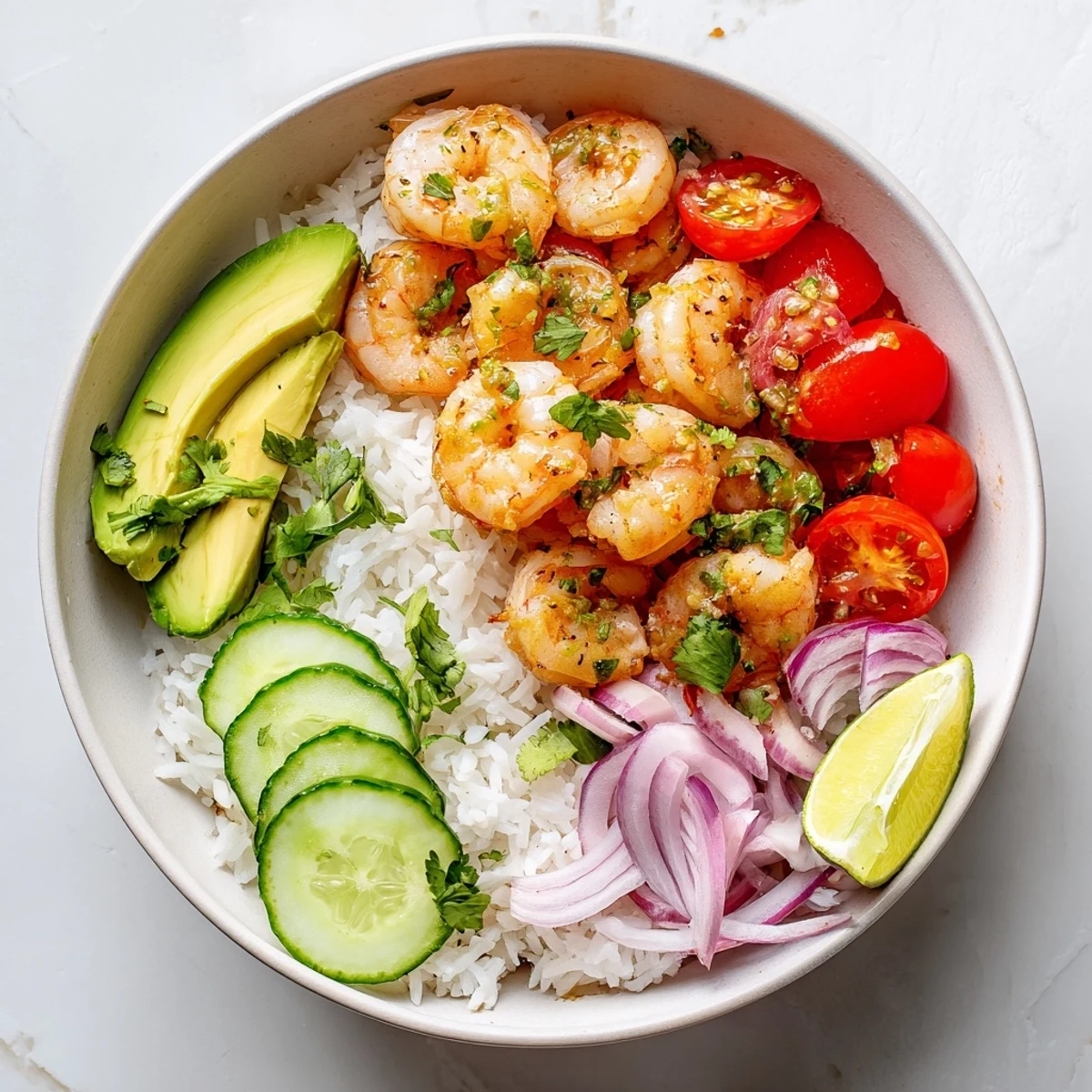 Savory garlic shrimp bowl recipe dinner arranged with crisp veggies and sliced avocado