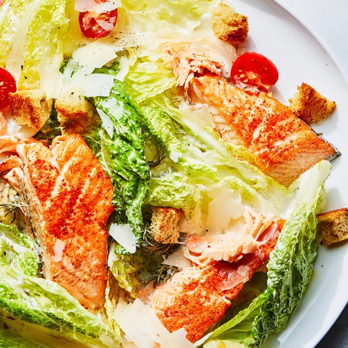 Homemade Smoky Salmon Caesar Salad featuring tender paprika-spiced salmon with crunchy garlic croutons