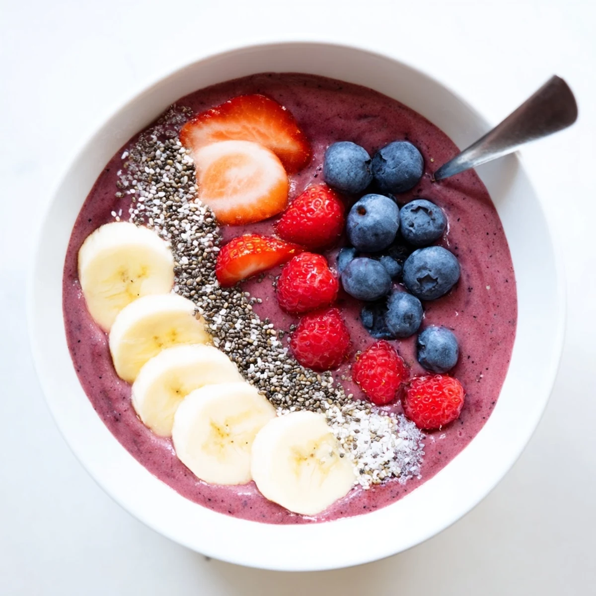 Creamy Summer Berry Smoothie in a glass, bright red-purple swirl, chilled