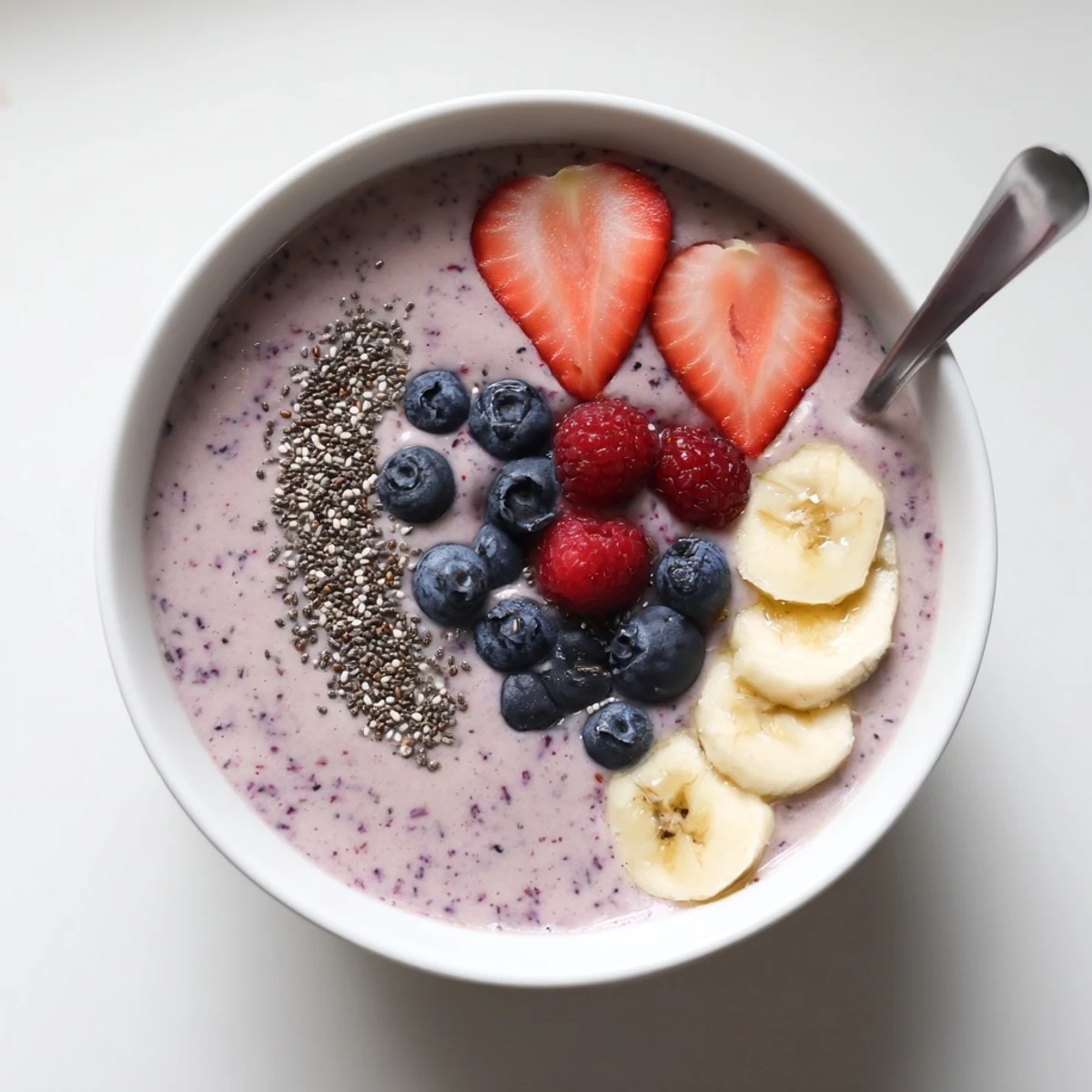 Refreshing Summer Berry Smoothie topped with fresh berries and crunchy granola