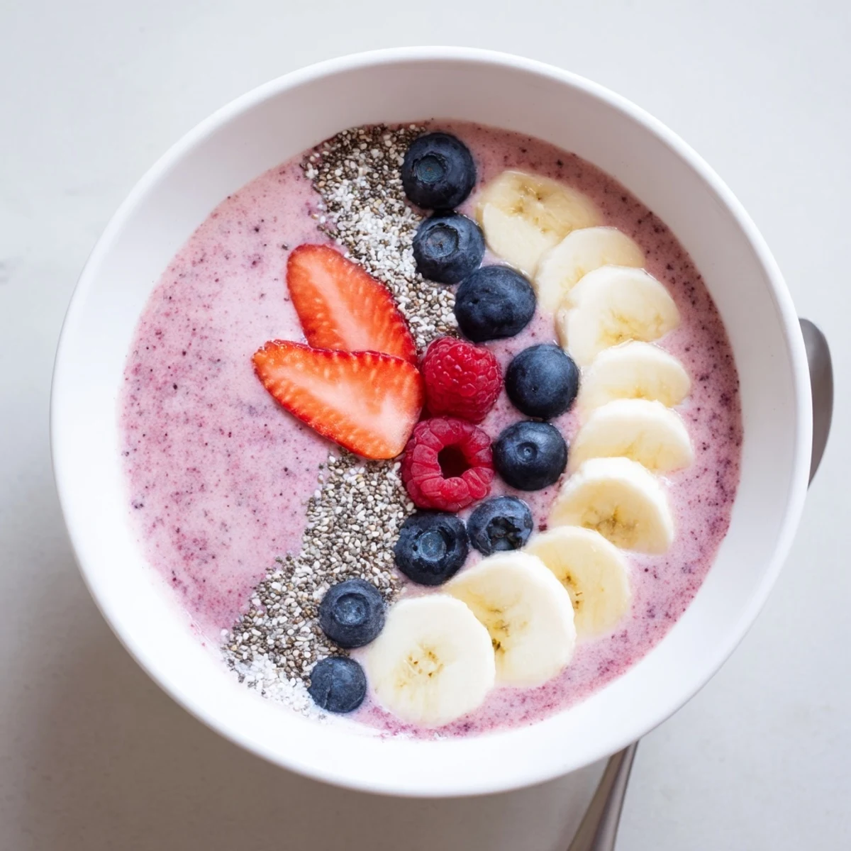 Frosty Summer Berry Smoothie poured beside a blender, lemon zest aroma