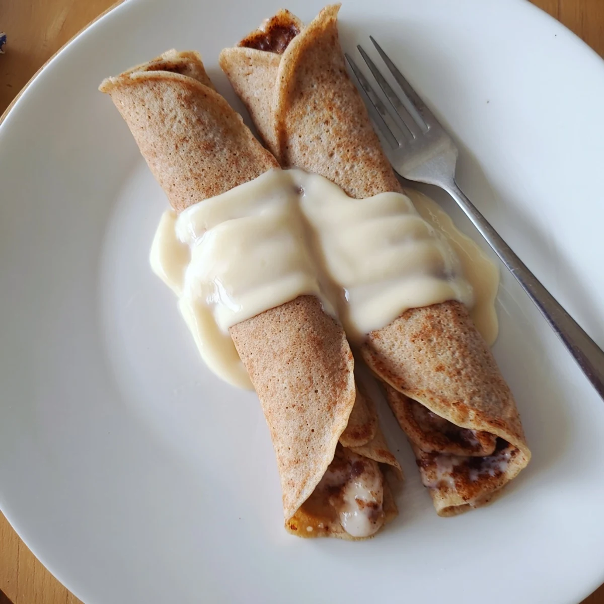 Thin cinnamon roll protein crepes rolled with a sweet spiced butter filling