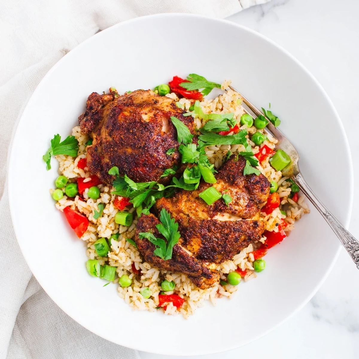 Vibrant spicy jerk chicken rice plated with bright peas and aromatic Caribbean seasonings