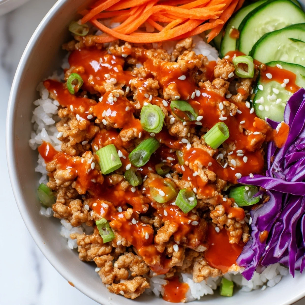 Ground Turkey Rice Bowls drizzled with spicy Bang Bang sauce over crisp vegetables