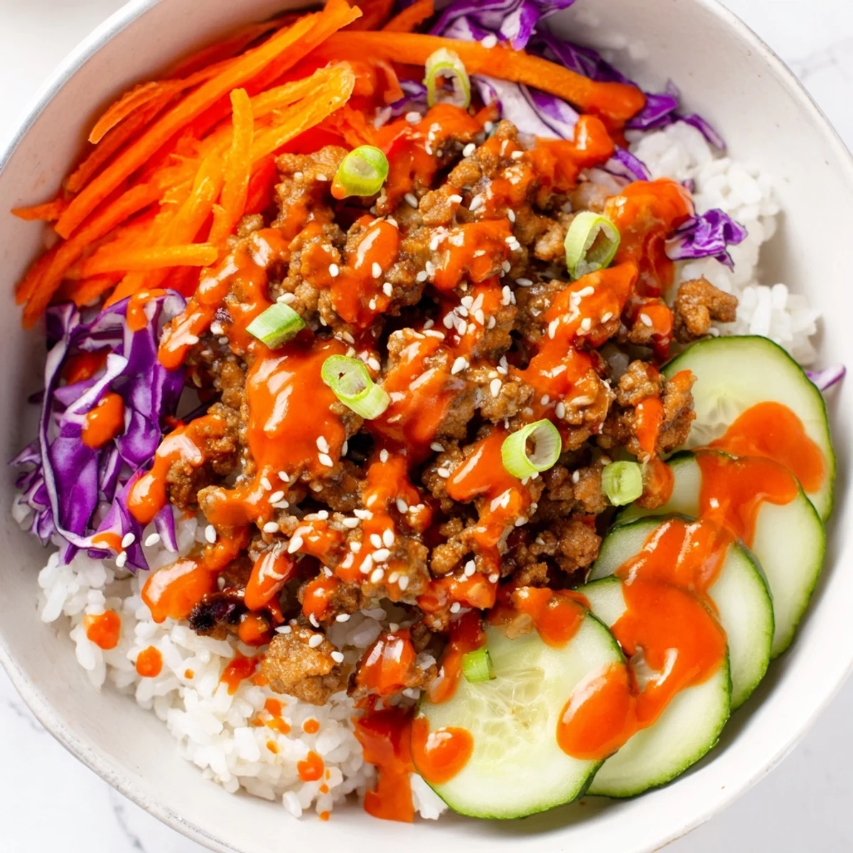Hearty Ground Turkey Rice Bowls with Bang Bang sauce served in white bowls