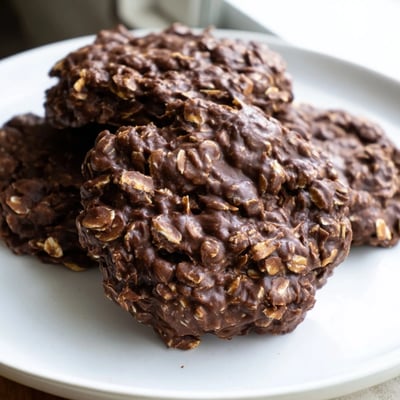 Glossy chocolate oatmeal no bake cookies cooling on a rustic baking sheet